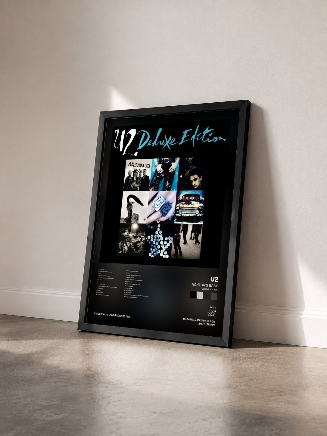 #noir Achtung Baby (Deluxe Edition) by U2 as a framed art print seen at an angle, black frame