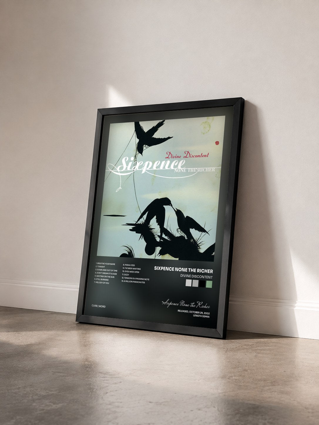#noir Tableau de l'album Divine Discontent de Sixpence None the Richer vu de trois quarts, cadre noir