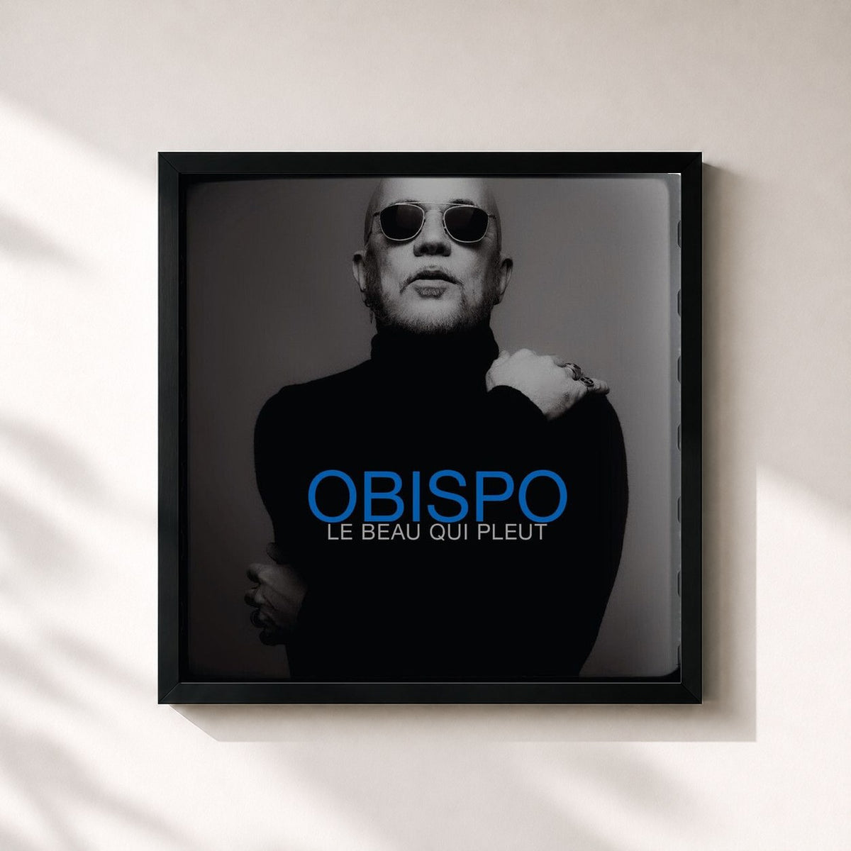 #noir Le beau qui pleut by Pascal Obispo as a square framed art print, black 32x32 cm frame