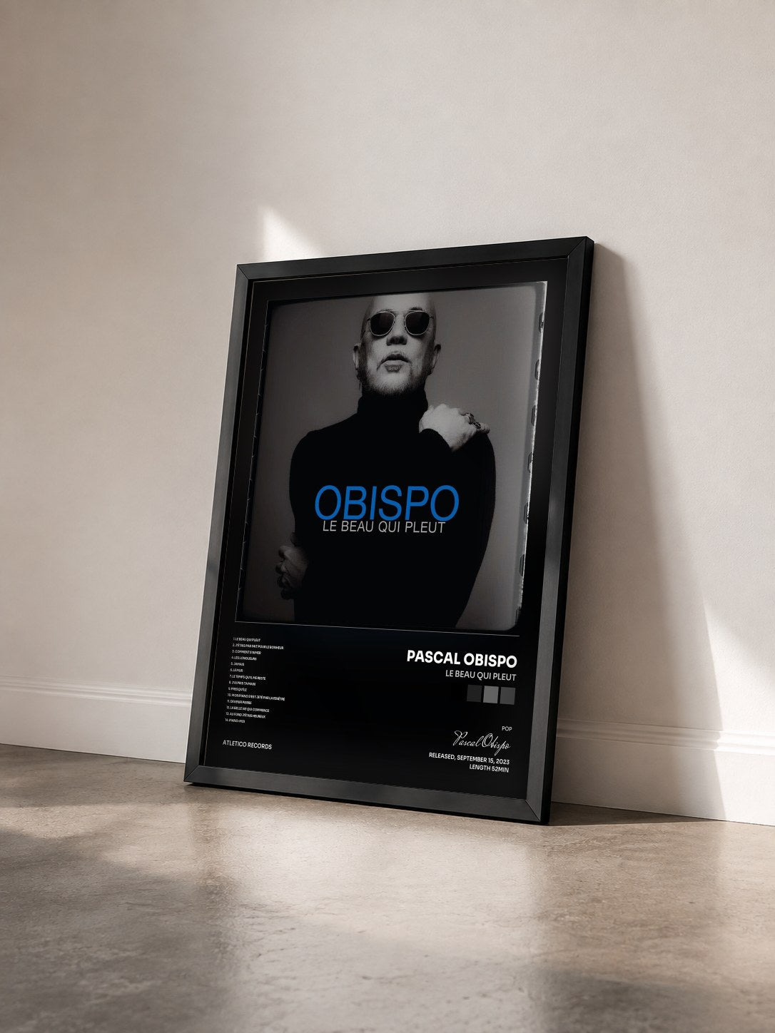 #noir Le beau qui pleut by Pascal Obispo as a framed art print seen at an angle, black frame