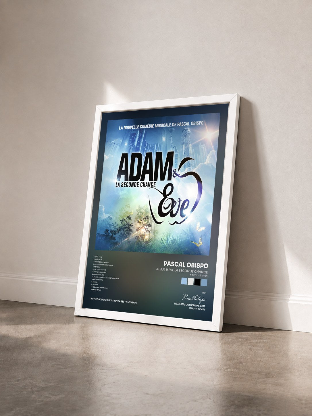 #blanc Adam & Eve La Seconde Chance (nouvelle édition) by Pascal Obispo as a framed art print seen at an angle, white frame