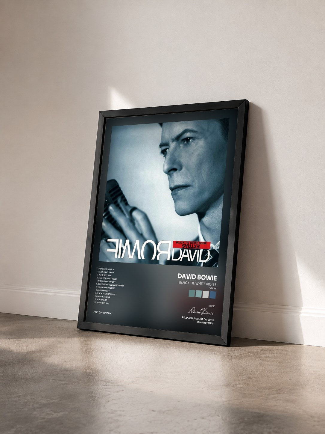 #noir Tableau de l'album Black Tie White Noise (Extras) de David Bowie vu de trois quarts, cadre noir