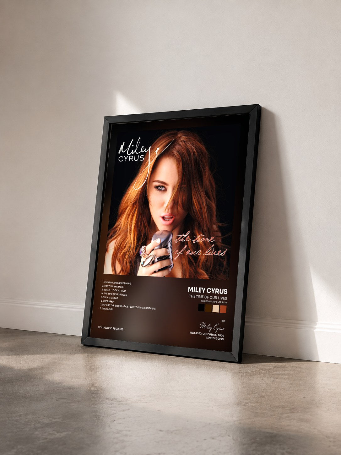 #noir The Time Of Our Lives (International Version) by Miley Cyrus as a framed art print seen at an angle, black frame