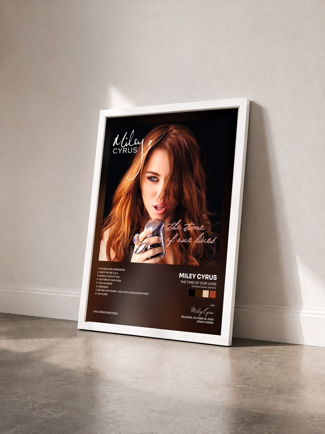 #blanc The Time Of Our Lives (International Version) by Miley Cyrus as a framed art print seen at an angle, white frame