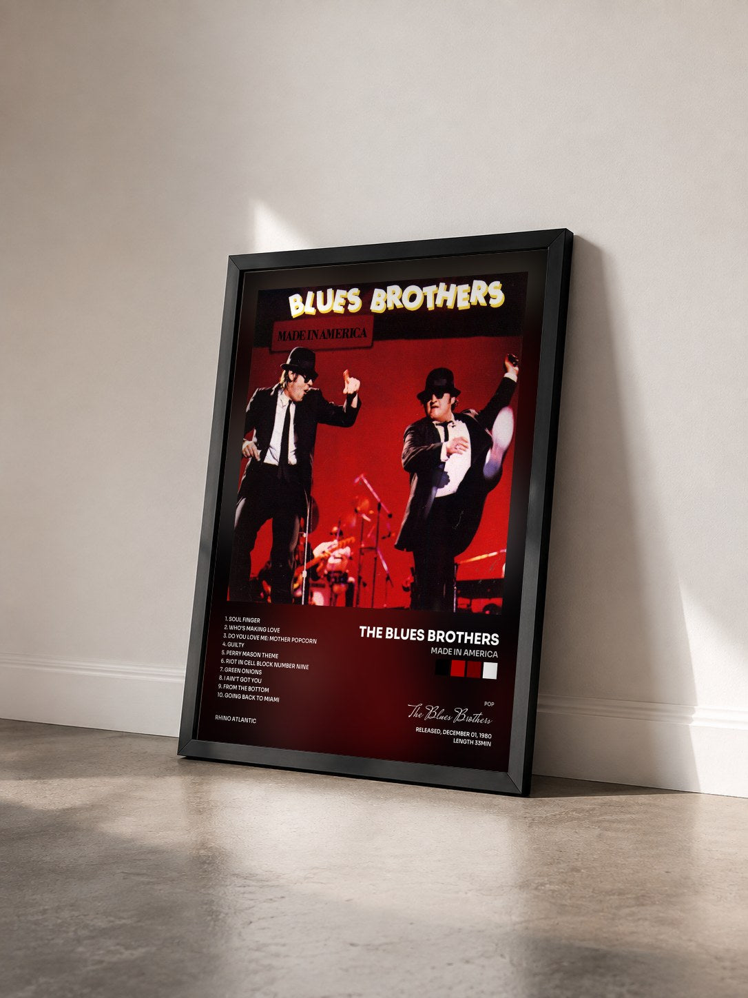 #noir Made in America by The Blues Brothers as a framed art print seen at an angle, black frame