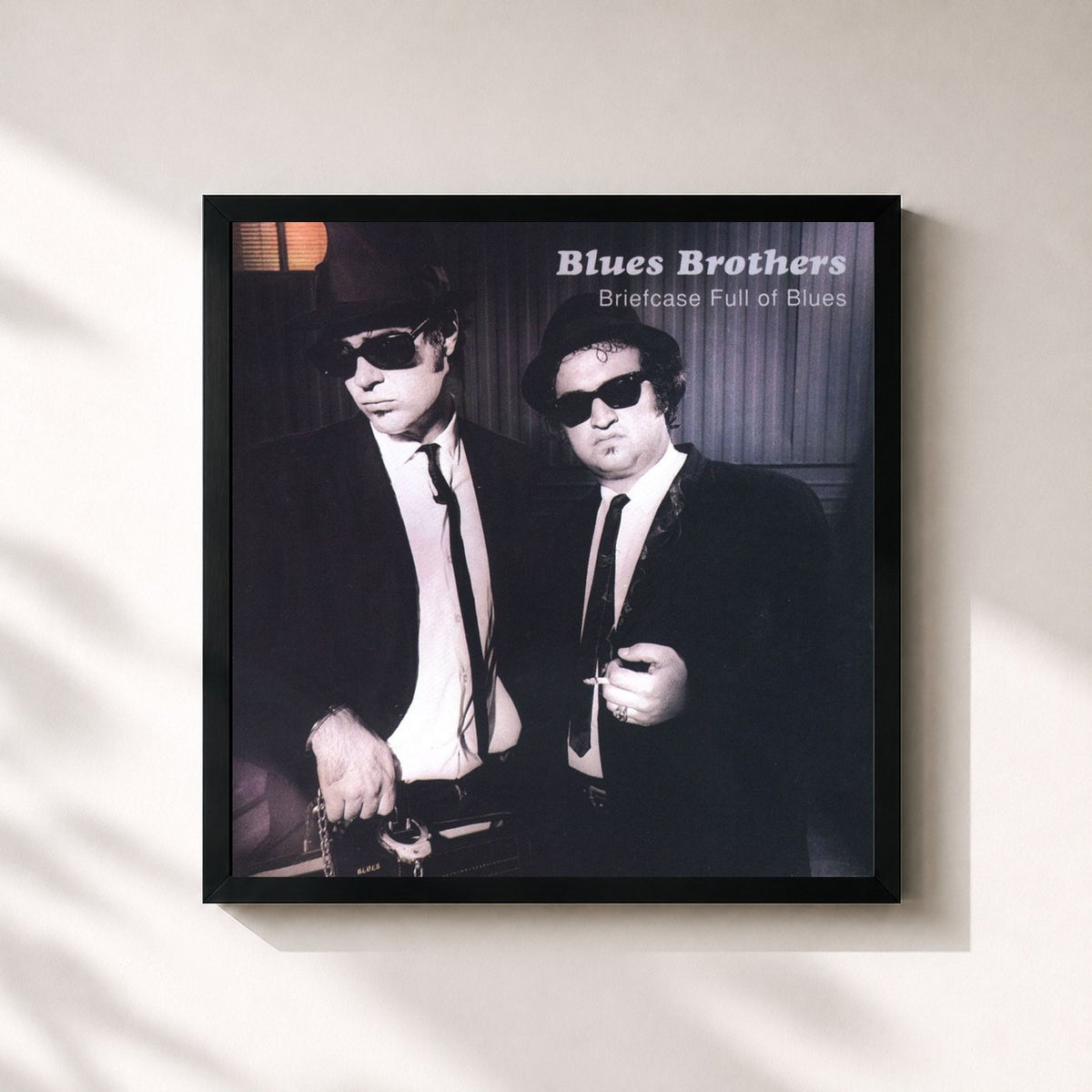 #noir Briefcase Full of Blues by The Blues Brothers as a square framed art print, black 32x32 cm frame