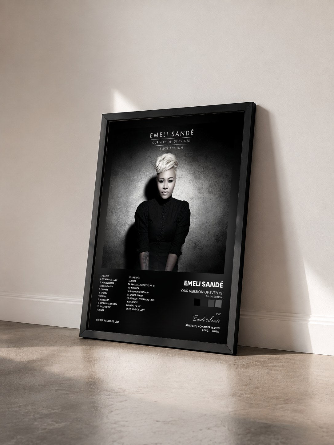 #noir Our Version Of Events (Deluxe Edition) by Emeli Sandé as a framed art print seen at an angle, black frame