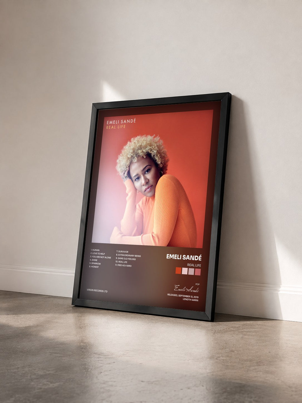 #noir REAL LIFE by Emeli Sandé as a framed art print seen at an angle, black frame