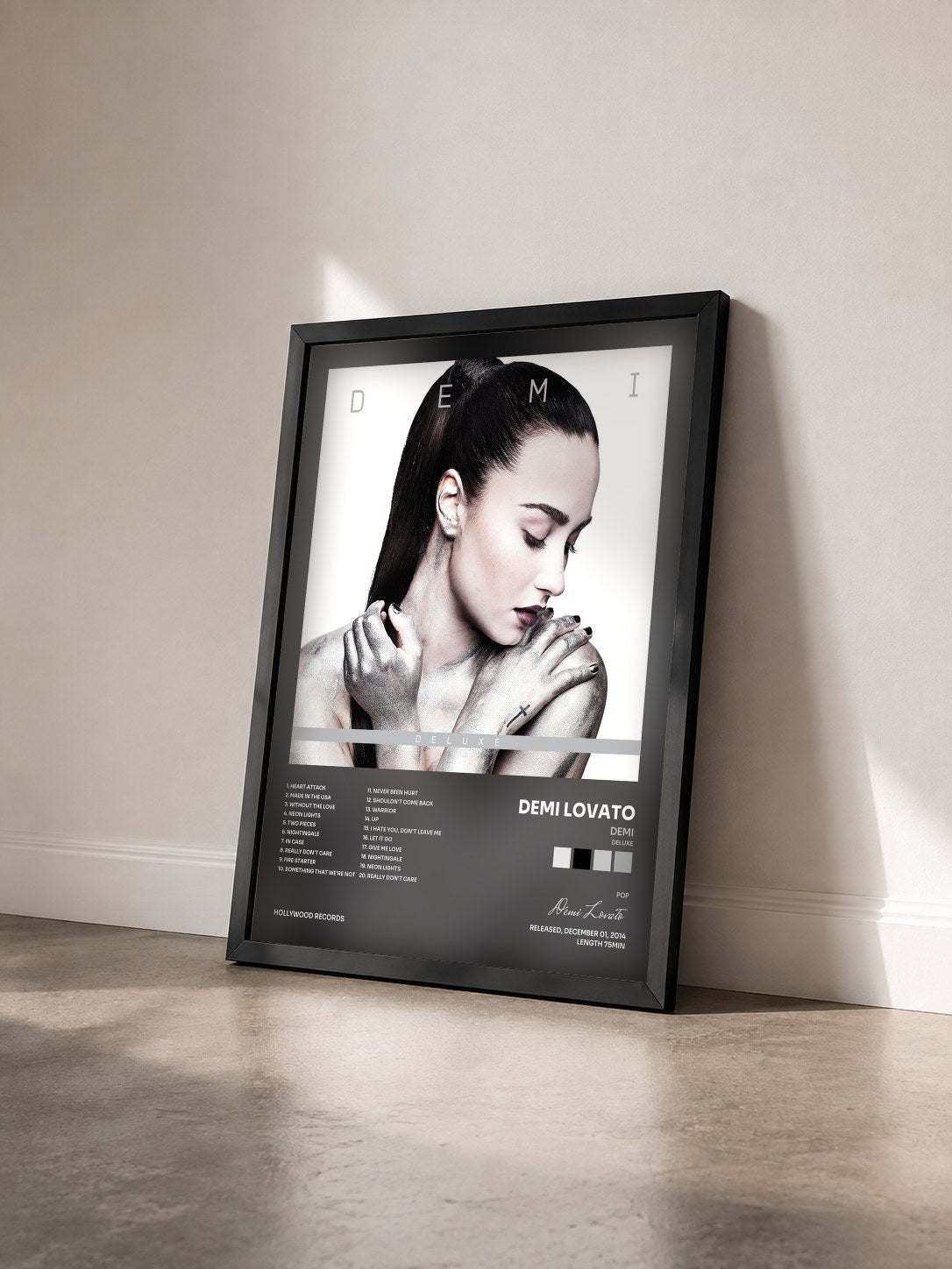 #noir Demi (Deluxe) by Demi Lovato as a framed art print seen at an angle, black frame