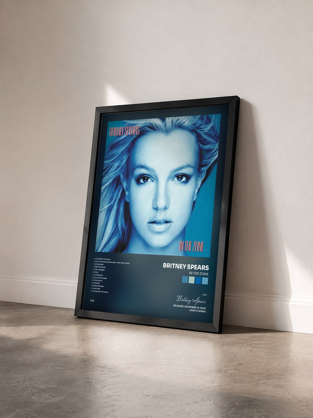#noir In The Zone by Britney Spears as a framed art print seen at an angle, black frame