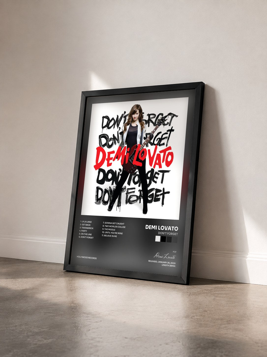 #noir Tableau de l'album Don't Forget de Demi Lovato vu de trois quarts, cadre noir