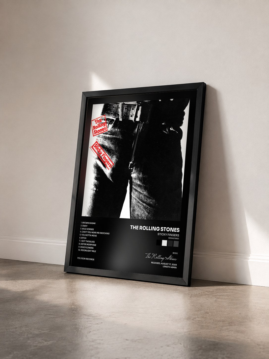 #noir Sticky Fingers (Remastered) by The Rolling Stones as a framed art print seen at an angle, black frame