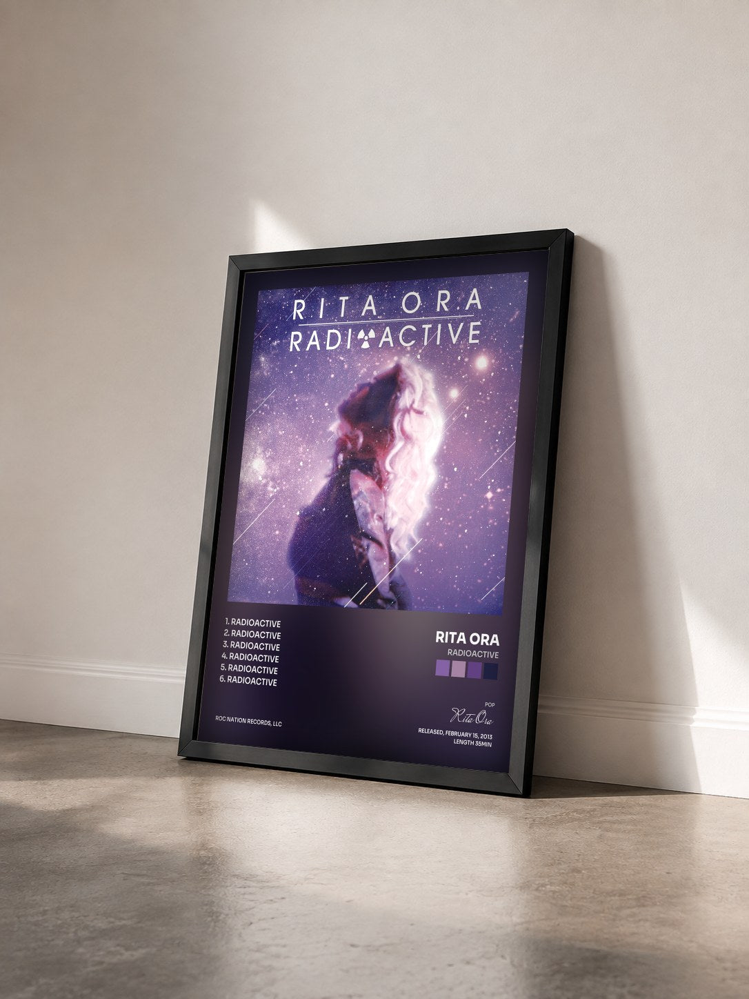 #noir Radioactive by Rita Ora as a framed art print seen at an angle, black frame