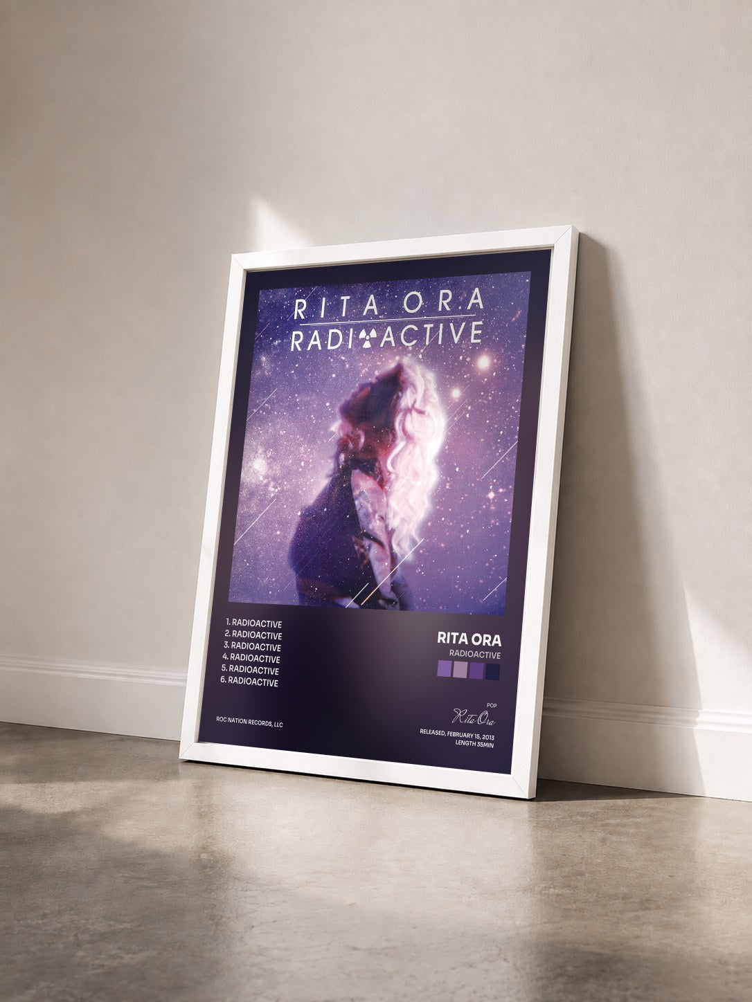 #blanc Radioactive by Rita Ora as a framed art print seen at an angle, white frame