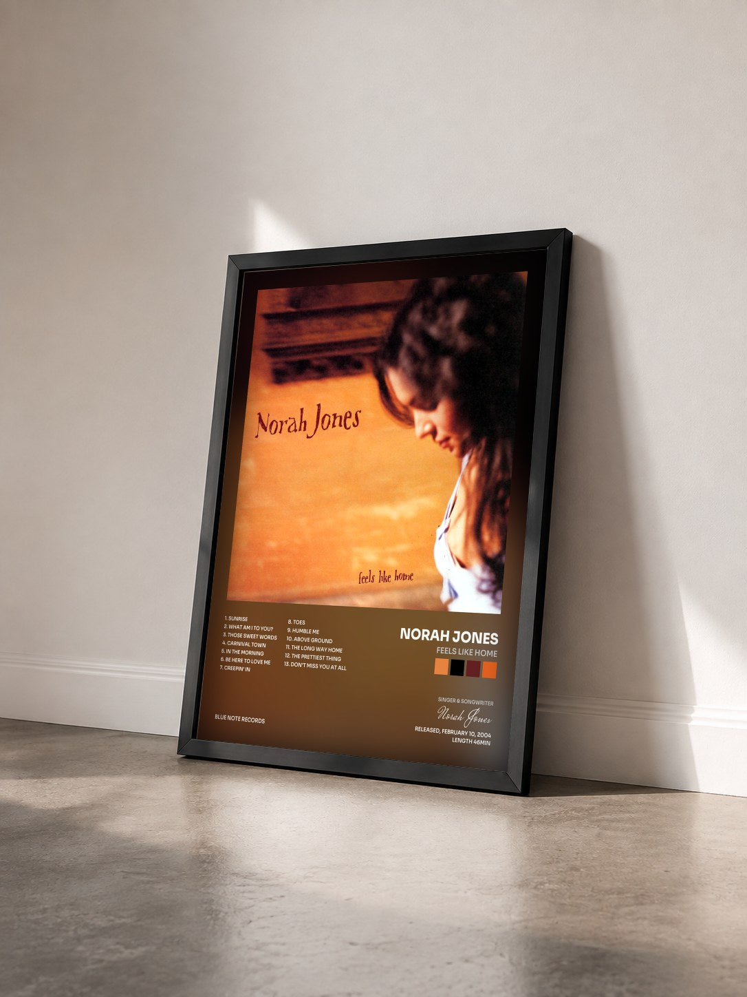 #noir Feels Like Home by Norah Jones as a framed art print seen at an angle, black frame
