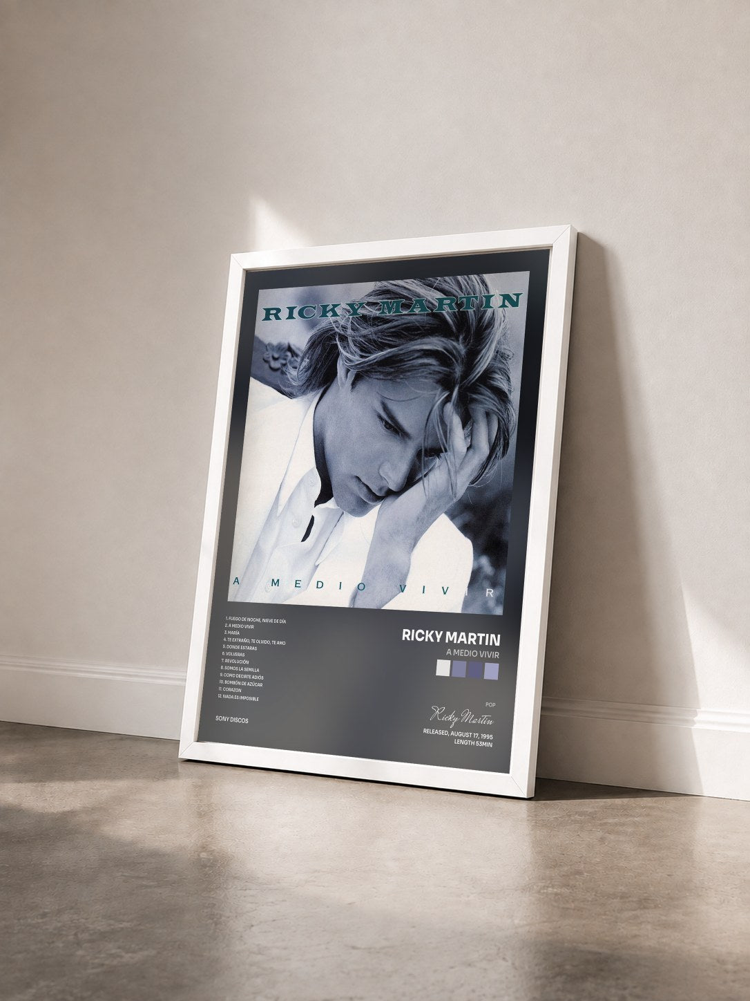 #blanc A Medio Vivir by Ricky Martin as a framed art print seen at an angle, white frame