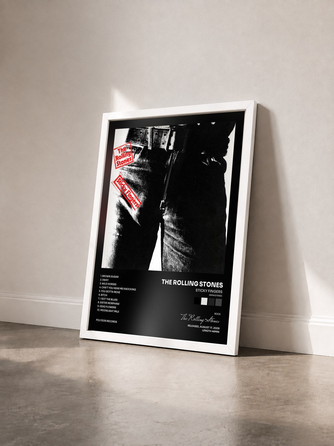 #blanc Sticky Fingers (Remastered) by The Rolling Stones as a framed art print seen at an angle, white frame