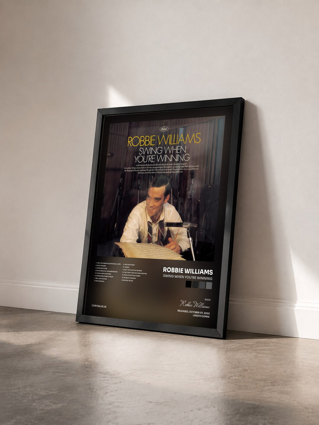 #noir Tableau de l'album Swing When You're Winning de Robbie Williams vu de trois quarts, cadre noir