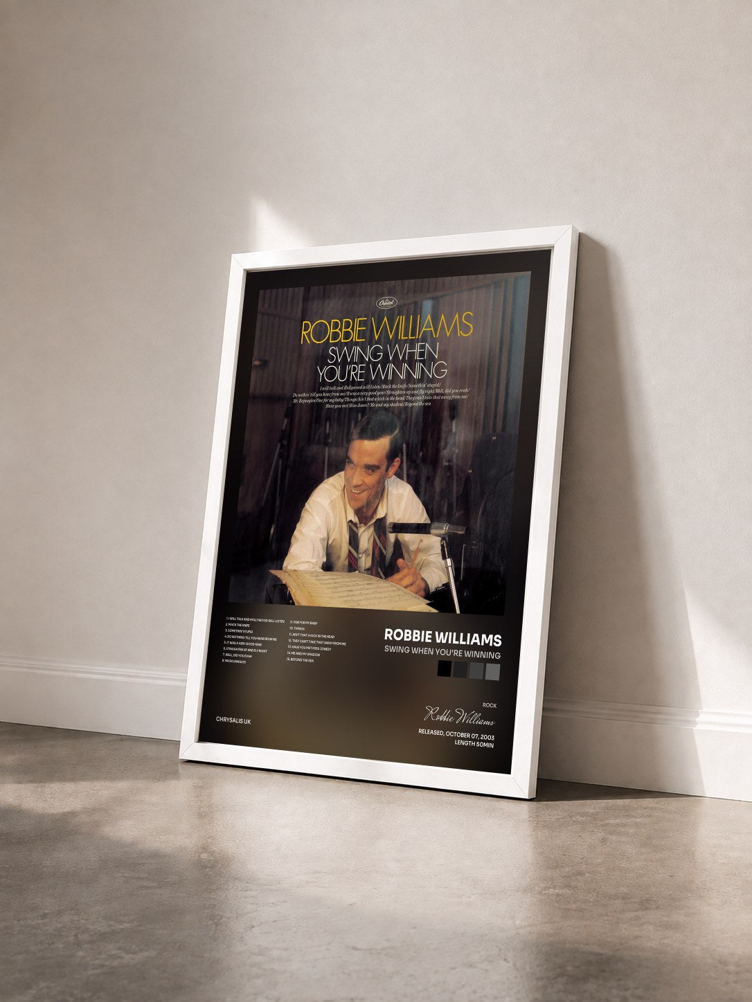 #blanc Swing When You're Winning by Robbie Williams as a framed art print seen at an angle, white frame