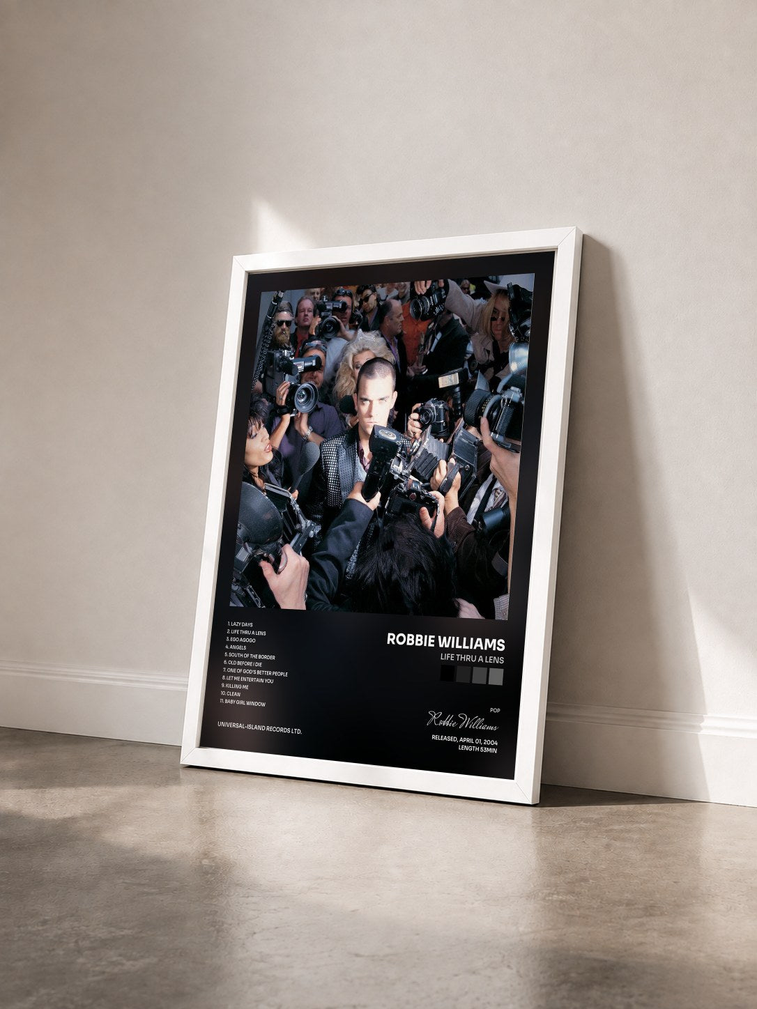 #blanc Tableau de l'album Life Thru A Lens de Robbie Williams vu de trois quarts, cadre blanc