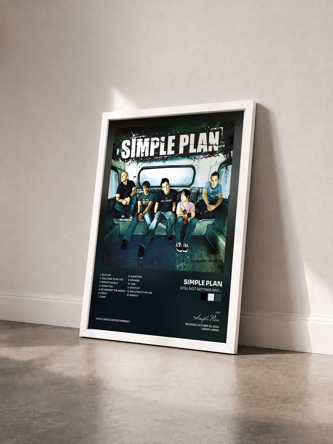 #blanc Tableau de l'album Still Not Getting Any... de Simple Plan vu de trois quarts, cadre blanc