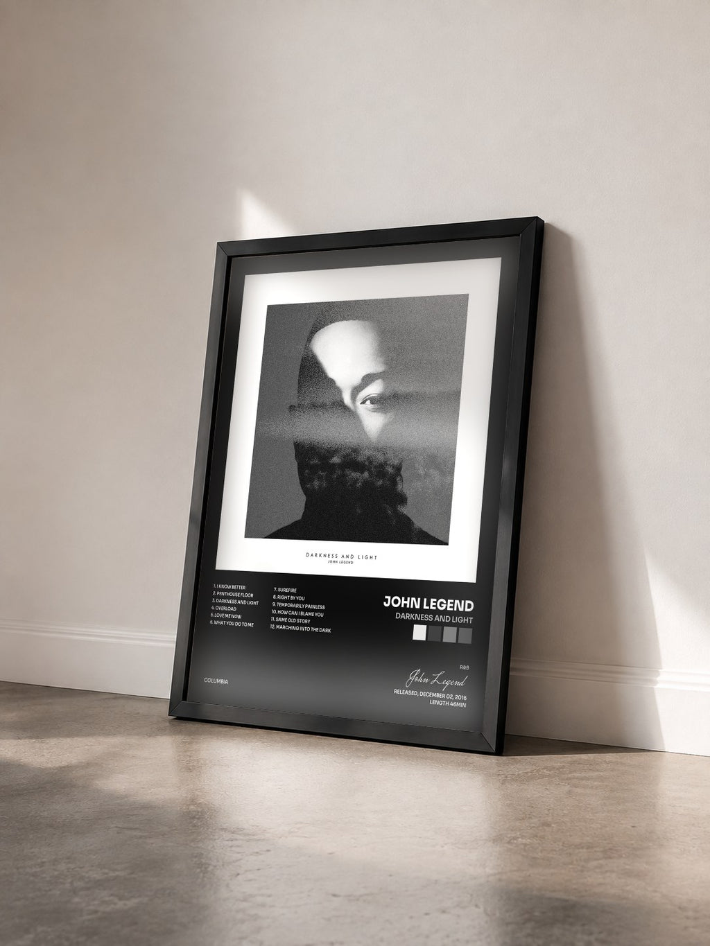 #noir Tableau de l'album DARKNESS AND LIGHT de John Legend vu de trois quarts, cadre noir
