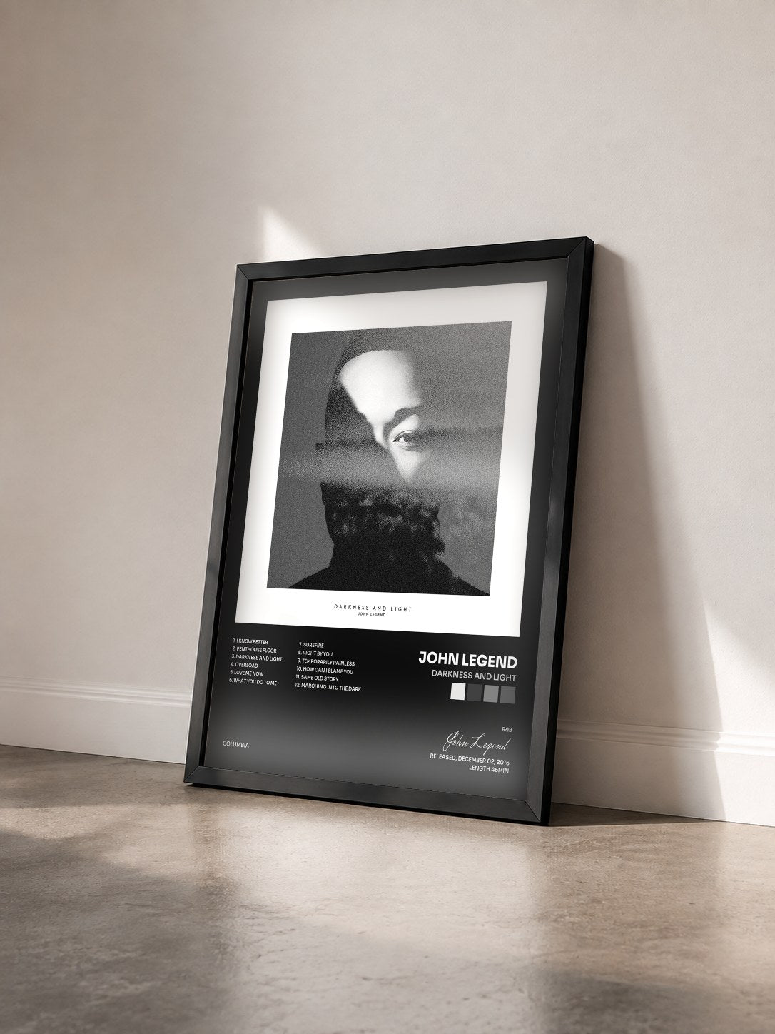 #noir Tableau de l'album DARKNESS AND LIGHT de John Legend vu de trois quarts, cadre noir