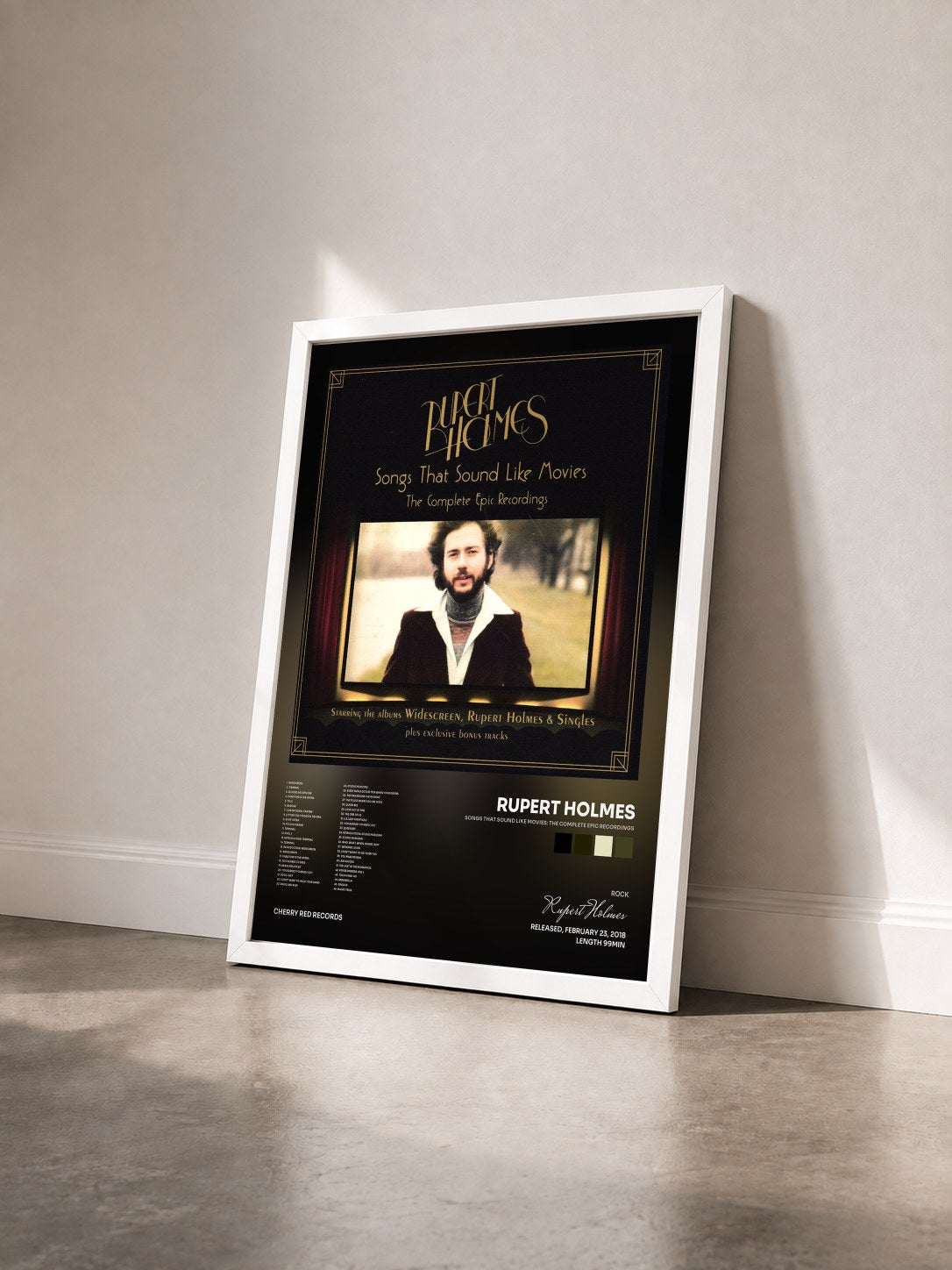 #blanc Tableau de l'album Songs That Sound Like Movies: The Complete Epic Recordings de Rupert Holmes vu de trois quarts, cadre blanc