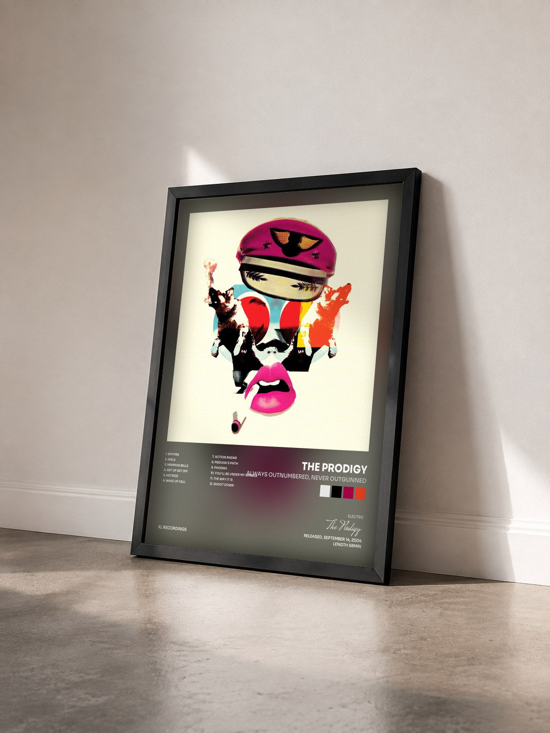 #noir Tableau de l'album Always Outnumbered, Never Outgunned de The Prodigy vu de trois quarts, cadre noir