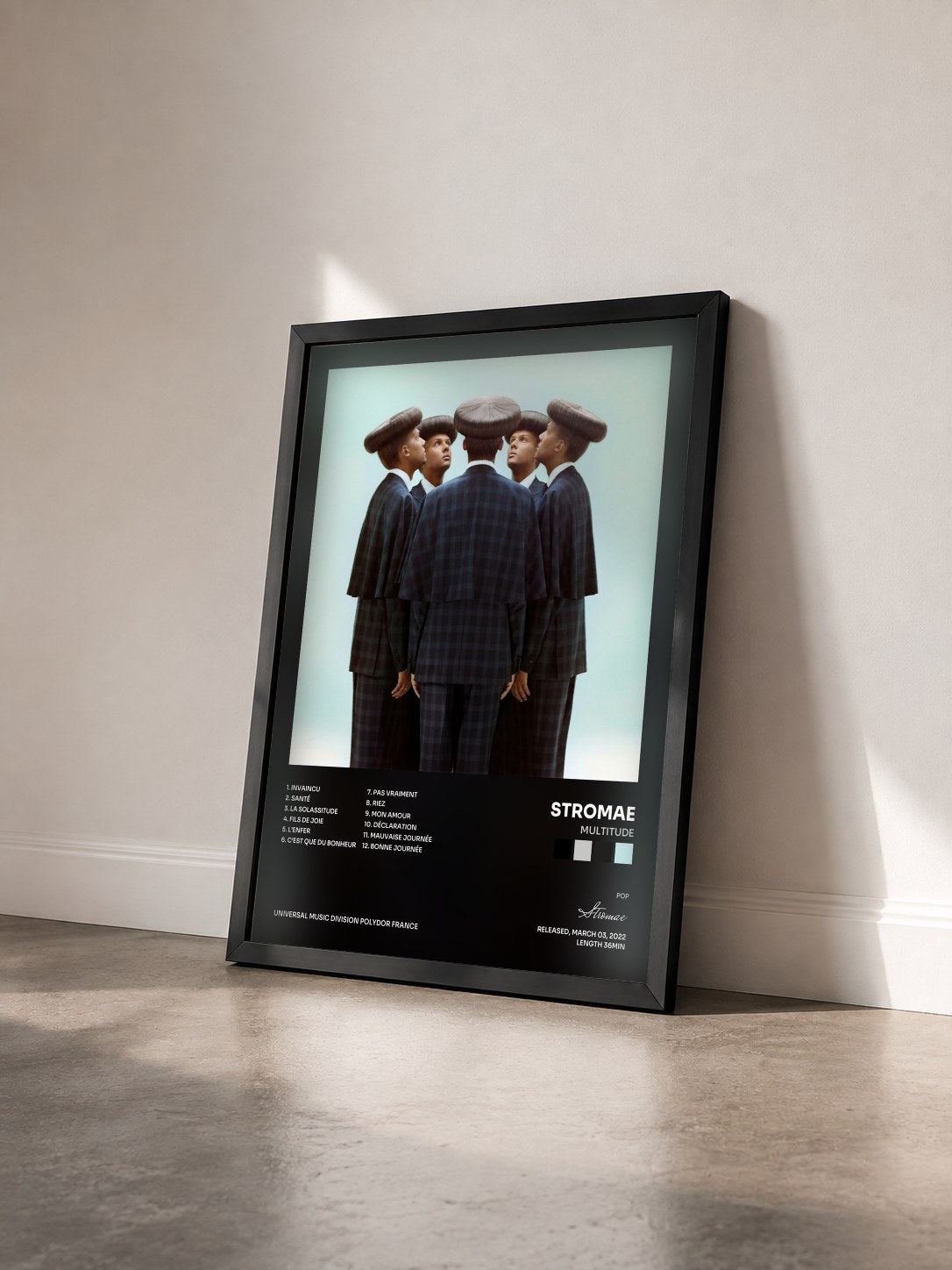 #noir Multitude by Stromae as a framed art print seen at an angle, black frame