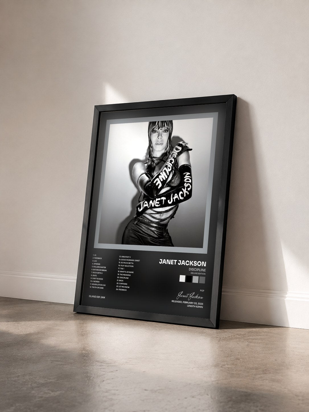 #noir Tableau de l'album Discipline (Deluxe Edition) de Janet Jackson vu de trois quarts, cadre noir