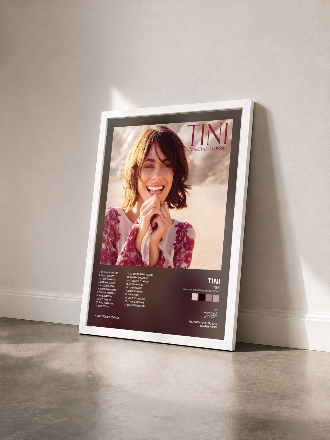#blanc TINI (Martina Stoessel) (Deluxe Edition) by TINI as a framed art print seen at an angle, white frame