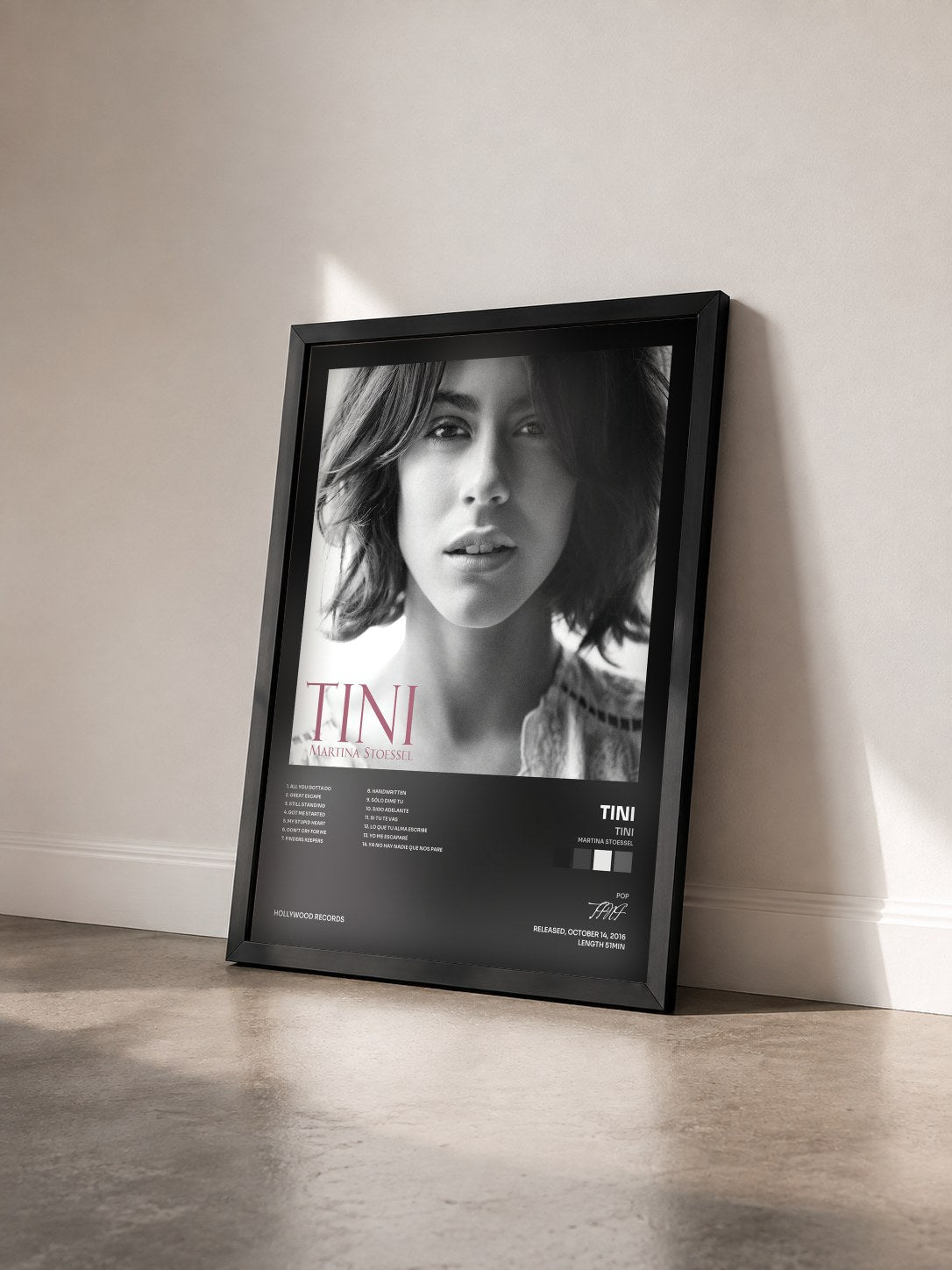 #noir TINI (Martina Stoessel) by TINI as a framed art print seen at an angle, black frame