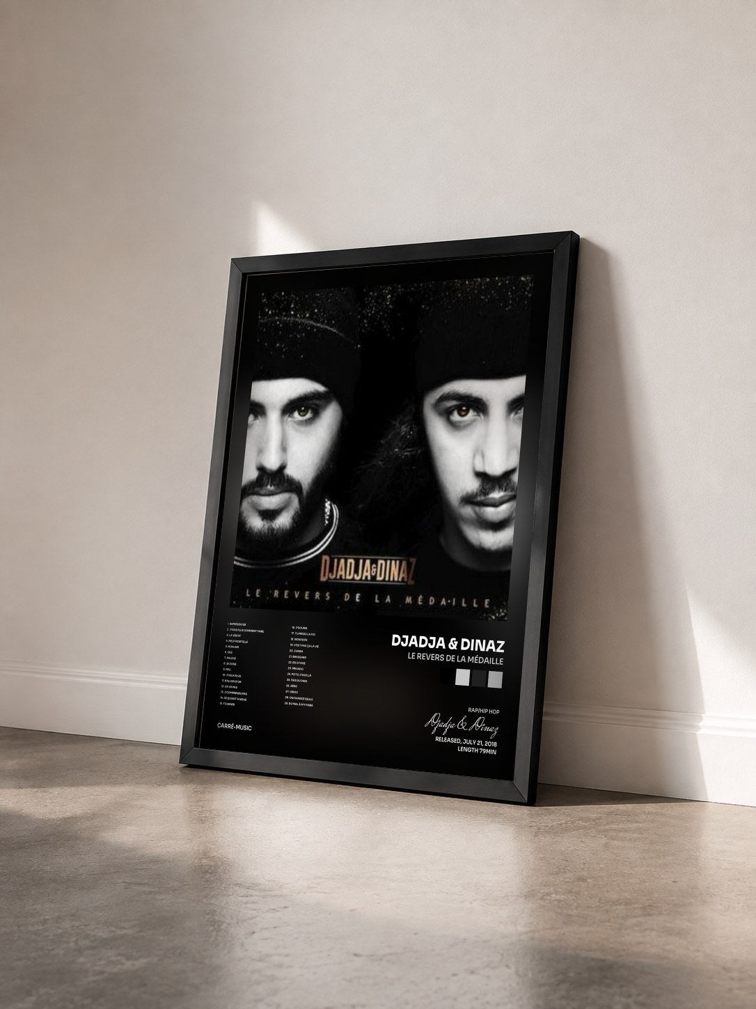 #noir Le revers by la médaille de Djadja & Dinaz as a framed art print seen at an angle, black frame