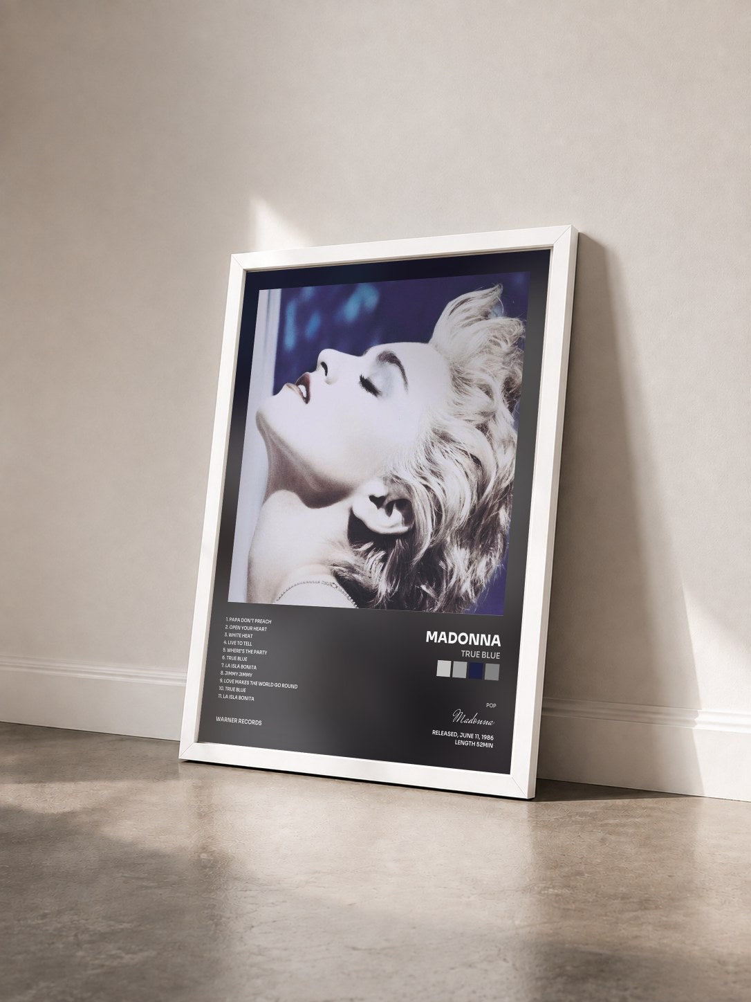 #blanc True Blue by Madonna as a framed art print seen at an angle, white frame