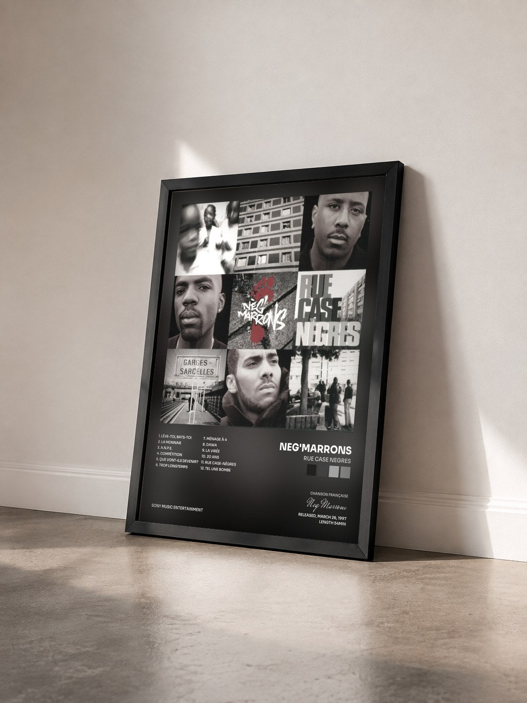 #noir Rue Case Negres by Neg'Marrons as a framed art print seen at an angle, black frame