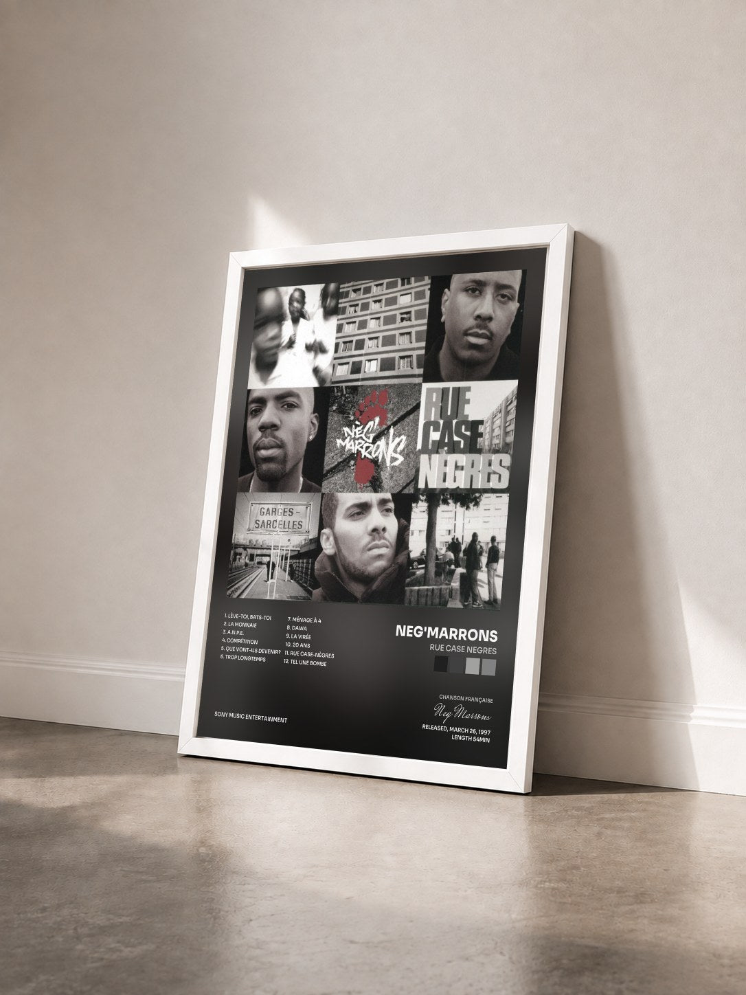 #blanc Rue Case Negres by Neg'Marrons as a framed art print seen at an angle, white frame