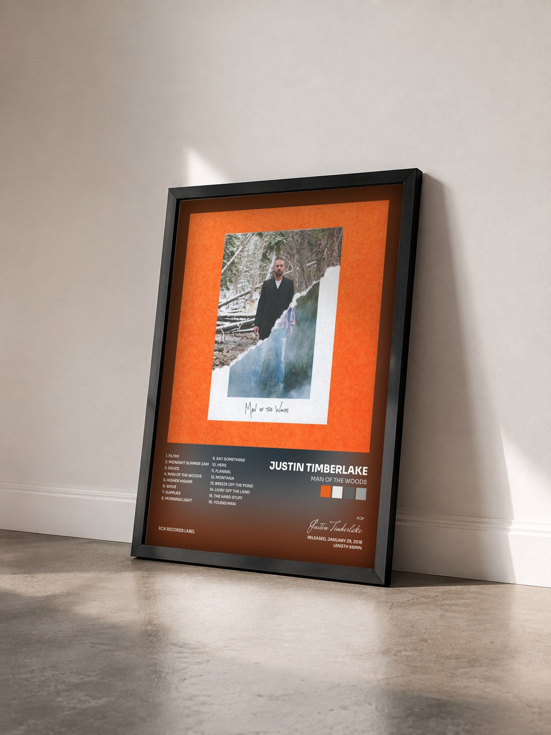 #noir Man of the Woods by Justin Timberlake as a framed art print seen at an angle, black frame