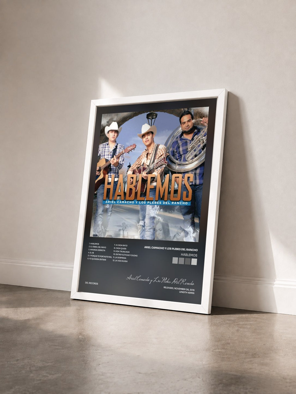 #blanc Hablemos by Ariel Camacho y Los Plebes Del Rancho as a framed art print seen at an angle, white frame