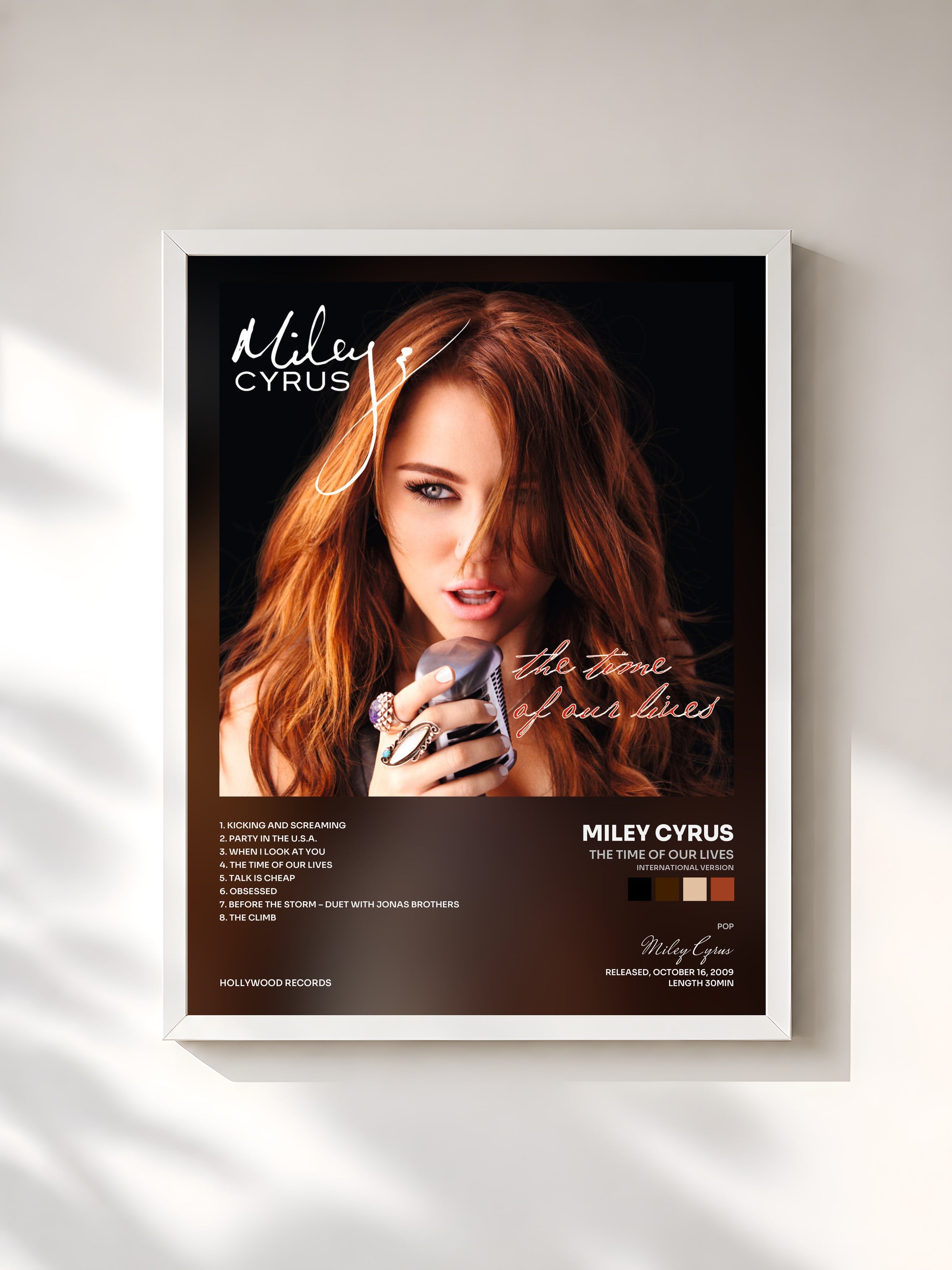 #blanc The Time Of Our Lives (International Version) by Miley Cyrus as a framed art print, white frame, printed and framed in France